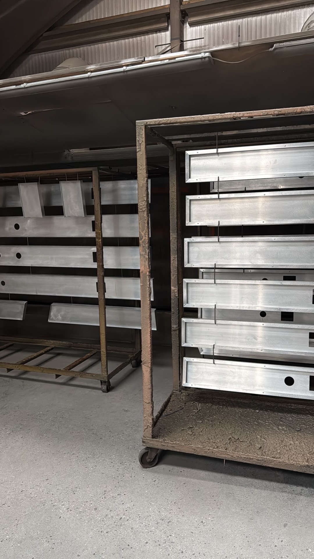 REVEAL 200mm aluminium channel sections racked in the workshop ahead of powder coating in RAL 9010 for the 22 Bishopsgate auditorium